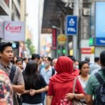 Busy street scene in Southeast Asia with people walking and shopping.