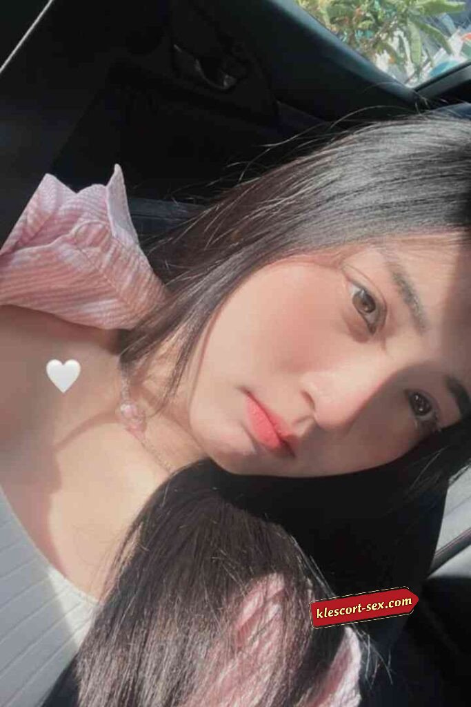 Beautiful Asian woman with long dark hair looking at the camera.