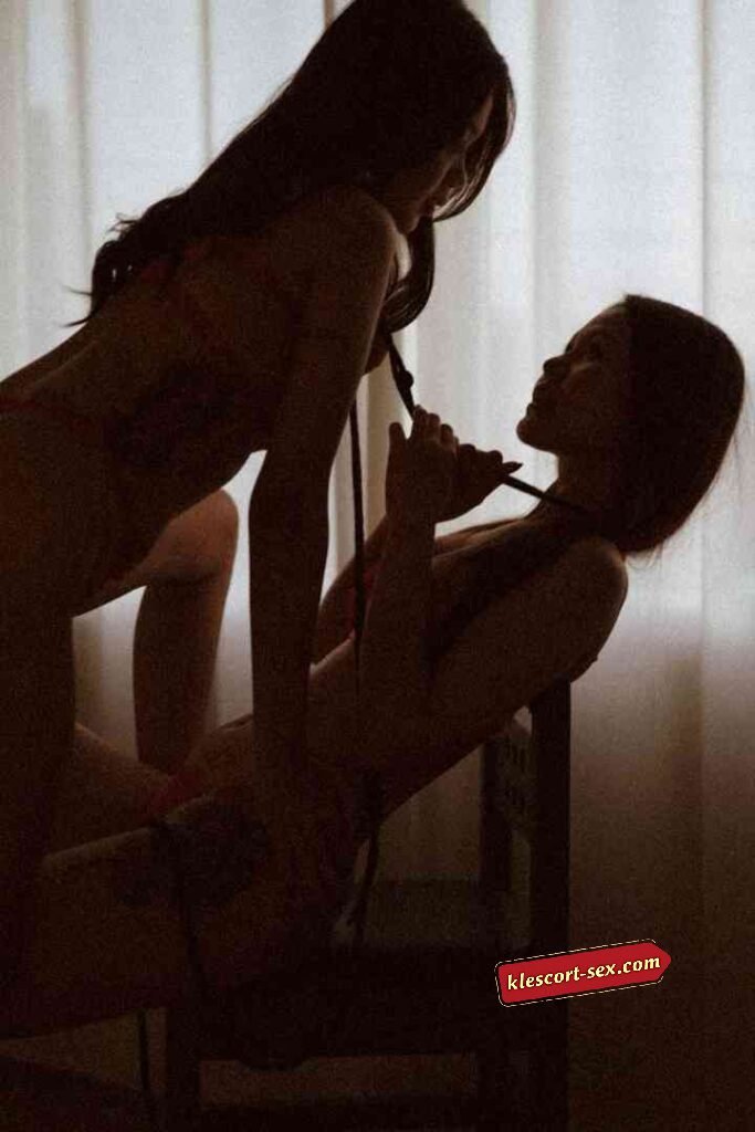 KL Escort Girl Two silhouetted figures in intimate pose, one pulling the other's hair. Sex Service Malaysia