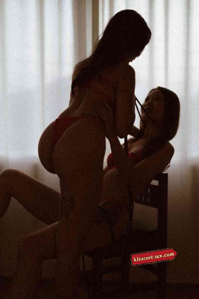 KL Escort Girl Silhouetted figures of two women in lingerie against a window Sex Service Malaysia