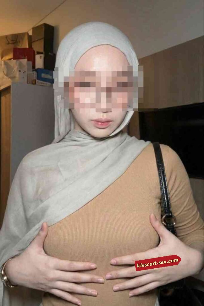 KL Escort Girl Woman in hijab and tan top holding her chest Sex Service Malaysia