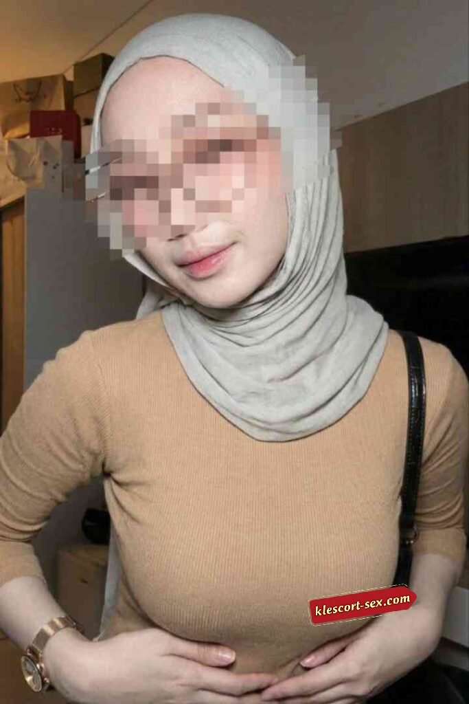 KL Escort Girl Woman wearing a tan long-sleeve shirt and a gray hijab Sex Service Malaysia