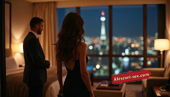 KL Escort Girl Couple in elegant attire overlooking a city skyline at night from a hotel room. Sex Service Malaysia